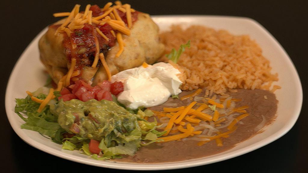 Chimichanga Plate · Deep fried flour tortilla with your choice of meat topped with cheese, lettuce, sour cream, guacamole sliced tomatoes, and special mild tomato sauce.