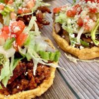 Sopes · Three sopes with refried beans topped with choice of meat (pastor, carnitas, chorizo, asada)...