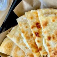 Cheese Quesadilla · 2 10'' flour tortillas with melted queso quesadilla. Side of Sour cream, Guac, and Roasted t...