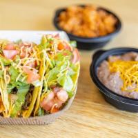 Taco Plate · 3 Tacos with choice of meat served with beans and rice.