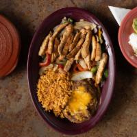 Fajitas · Served with choice of tortillas, rice, refried beans, and a fajita condiment plate (guacamol...
