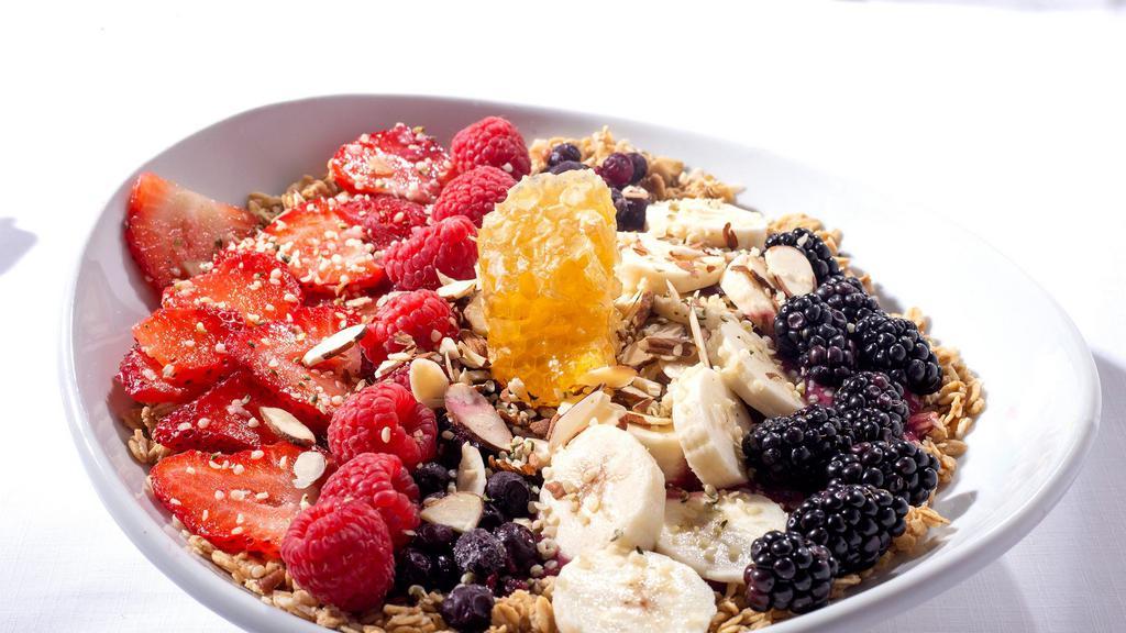Acai Super Bowl · A mixture of frozen strawberries, blackberries, raspberries, huckleberries and acai powder blended with almond milk, vanilla & honeycomb, atop a bed of almond granola. Topped with almonds, banana, huckleberries, strawberries, honeycomb & hemp seeds. Gluten friendly and vegetarian.