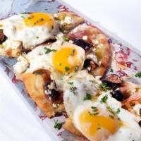 Egg, Prosciutto & Fig, Goat Cheese Pizza · A traditional flat bread topped with garlic chutney, sliced ripe figs, goat cheese, prosciut...