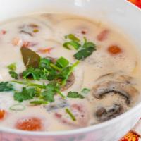 Vegan Tom Kha · Coconut milk soup with galangal, kaffir lime leaves, lemongrass, tomato, onions, and mushrooms