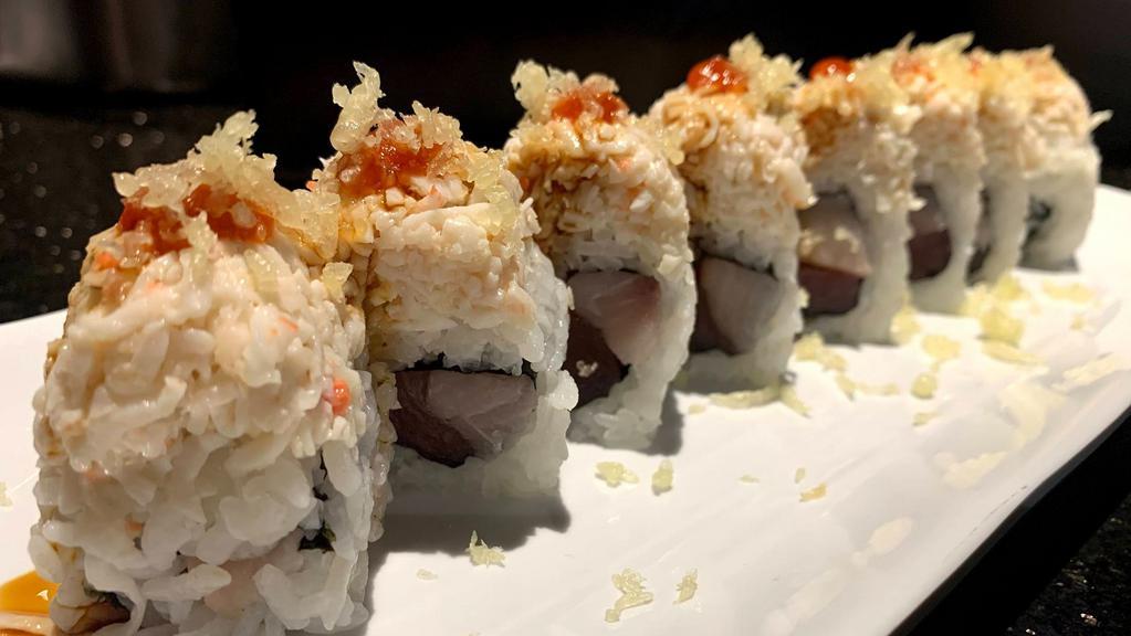 Dynamite · spicy. Tuna and yellowtail roll topped with crab, eel sauce, chili sauce, and tempura crunchies