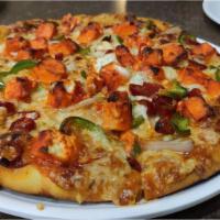 Chicken Tikka Pizza · Freshly baked cheese pizza topped with chicken with buffalo sauce.