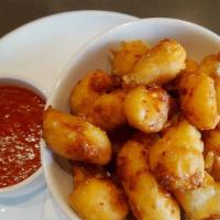 Cheese Curds · Breaded and Fried Wisconsin Cheese Curds sticks served with Marinara