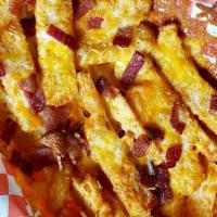 Bacon Cheese Fries · Steak Fries covered in 3 melted Cheese, and Smoked Bacon served in a Basket.