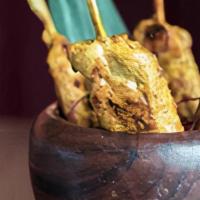 Chicken Satay · Charcoal-grilled chicken skewers, marinated in turmeric, coriander, and coconut milk.