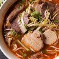 Hue Style Beef Shank Noodle Soup / Bún Bò Huế   · Round shanghai rice noodles, beef shank, slices of chả lụa, and pork picnic in a spicy lemon...