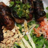Betel Leaf Beef · Minced beef wrapped with betel leaves and grilled  served with vermicelli noodles, mixed gre...