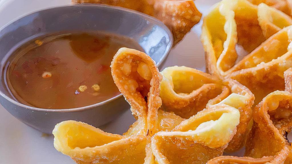 Crab Cheese Wonton · Deep fried wonton wrapped with cream cheese a crab meat served with sweet & sour sauce.