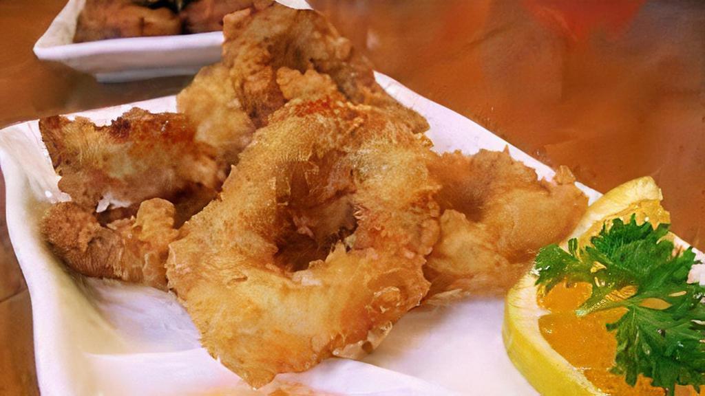Thai Calamari · Deep fried calamari marinated with special herbs served with sweet & sour sauce.
