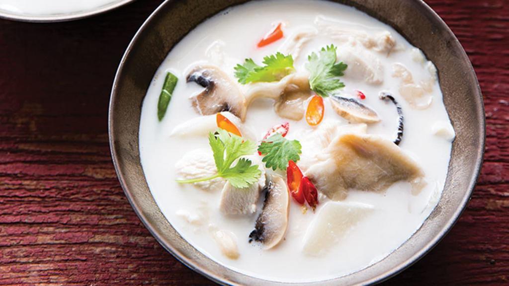 Tom Kha · Hot and sour coconut soup with chicken, tomato, onion, galangal, lime leaves, lemongrass, and mushroom.