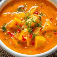 Pumpkin Curry · Red curry paste in coconut milk with bell peppers, pumpkin, and Thai basil.