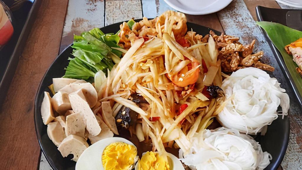 Tam Tard · Thai or Laos style papaya salad with vermicelli rice noodle, boiled egg, pork cracklings, & Vietnamese sausage, shrimp, cucumber, & bean sprout.