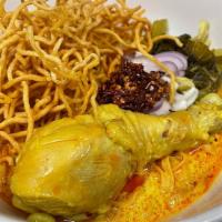 Khao Soi · Classic large curry soup dish from northern Thailand with eggs noodles, coconut milk, and gi...