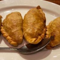 Curry Puff · Homemade pastry stuffed with potato, chicken & curry paste.