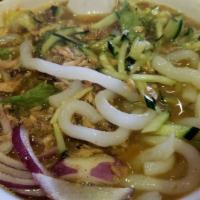 Asam Laksa · Spicy and sour rice noodles served in chef's special lemon grass broth with fish flakes, on ...