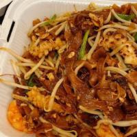 Char Kway Teow · Famous stir fried flat rice noodles with fresh shrimp, squid, bean sprouts, egg, soy sauce a...