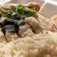 Hainanese Chicken · Chicken rice subtly flavored with steam chicken and chef's special soy sauce.