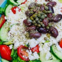 Greek Salad - D · Ribbon cut Romaine, cucumbers, grape tomatoes, Kalamata olives, capers, feta cheese and Gree...
