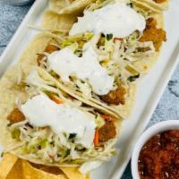 Cod Tacos - D · 4 corn tortillas filled with crispy breaded Alaskan cod, cabbage salsa and cilantro lime cre...