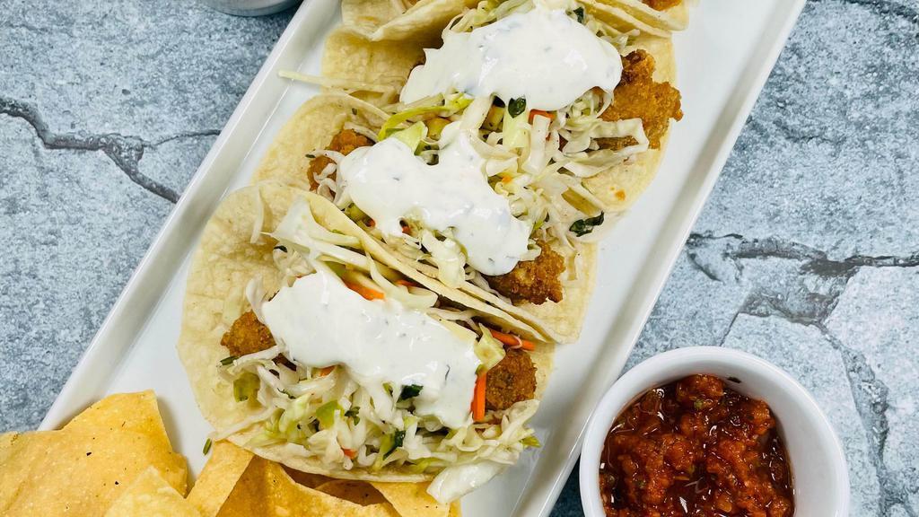 Cod Tacos - D · 4 corn tortillas filled with crispy breaded Alaskan cod, cabbage salsa and cilantro lime crema. Served with house made chips, salsa verde and rojo.