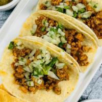 Chipotle Chicken Tacos - D · 3 corn tortillas filled with chipotle lime chicken, topped with cilantro/onion mix. Served w...