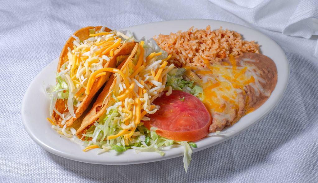 Taco Plate - Hard · Three hard shell corn tacos, choice of beef or chicken, comes with lettuce, tomatoes, cheese, and sour creme.