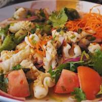 Squid Salad (Yum Pla Muek) · Spice squid with onion, lime juice, and fresh chili.
