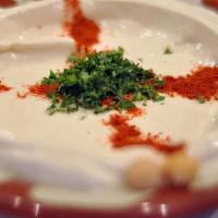 Hummus · A puree of chickpeas, sesame, lemon juice, and salt. Topped with paprika and olive oil. Serv...
