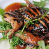 Quail · Grilled quail marinated in saffron, olive oil, and spices.