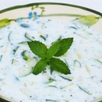 Cucumber Yogurt · Fresh yogurt blended with diced cucumber, dry mint, garlic, and lemon juice.