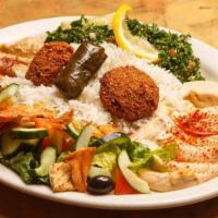 Vegetarian Lovers · Contains gluten. A combination plate of hummus, Baba ghonouj, grape leaves, falafel, fattous...