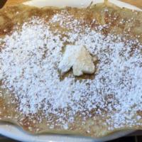 Banana Pancakes · Full stack of 5 pancakes. Stuffed and topped with bananas and sprinkled with powdered sugar.