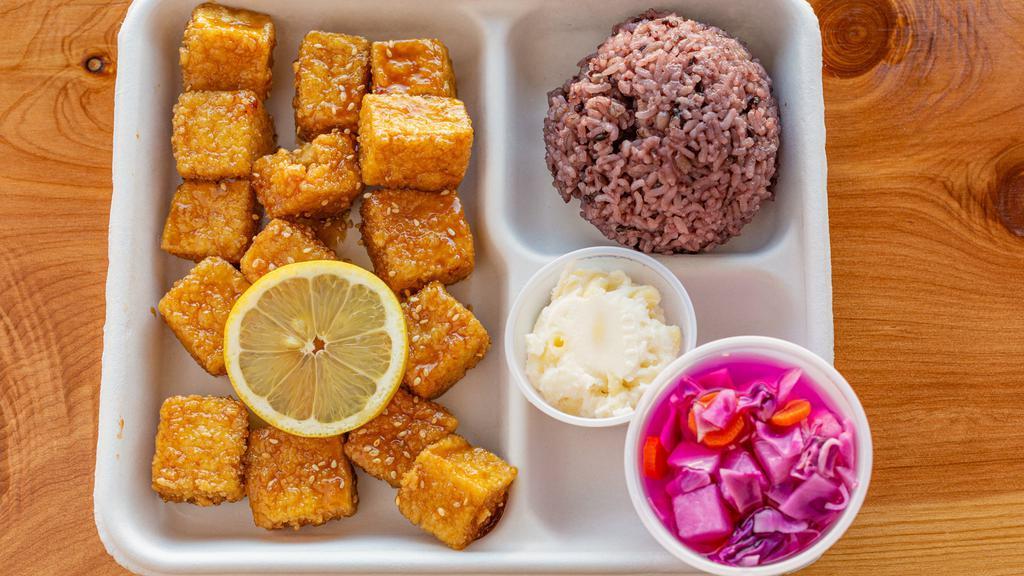 Tofu Nuggets · Lightly fried, sliced cube Tofu Nuggets.
Deep fried coated with Corn Starch.
Choice of Honey spicy or Honey soy sauce. 
Served with House made purple rice, Potato mash & macaroni.