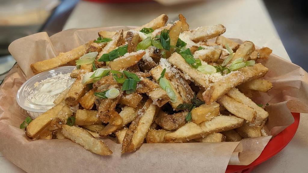 Truffle Fries · hand cut french fries, tossed in our special truffle blend, topped with parmesan cheese and green onions, served with a side of our garlic aioli