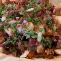 Poutine Fries · basket of french fries with cheese curds, covered in brown gravy, crispy bacon, finished wit...