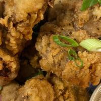 Chicken Gizzards · fried chicken gizzards, served with a side of brown gravy, finished with green onions