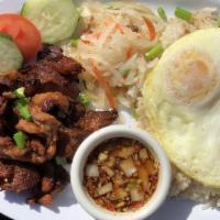 Tapsilog · Thin sliced marinated beef. Served with Garlic Fried Rice and two fried eggs