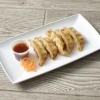 Ginger Pork Gyoza · Hapa's pork potstickers served with a spicy soy sauce.