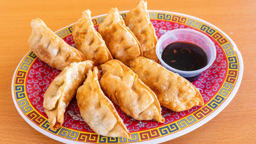 Fried Dumpling 锅贴 · 8 pieces. Pork and cabbage wraps and then fried them.