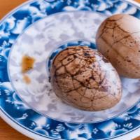 Tea-Stewed Egg 茶叶蛋 · Eggs boiled in the black tea and some special seasoning.