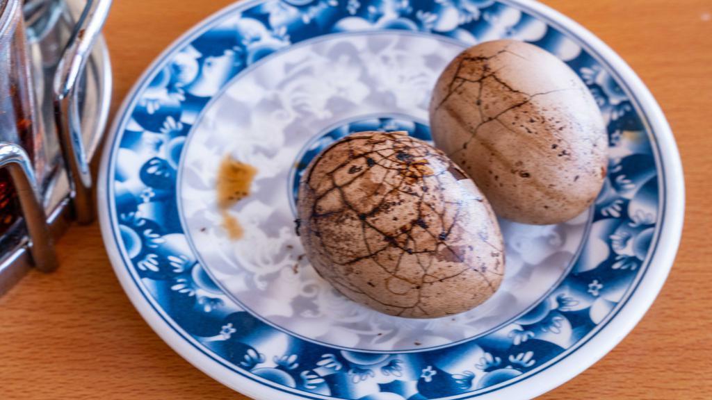 Tea-Stewed Egg 茶叶蛋 · Eggs boiled in the black tea and some special seasoning.