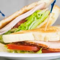 Turkey, Lettuce, Tomato · Turkey, Lettuce and Tomato served on toasted white bread with mayonnaise