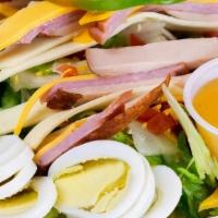 Chef Salad · Ham and turkey served on lettuce with tomatoes, swiss cheese, American cheese, cucumbers, cr...