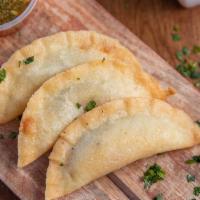 Empanadas · 3 Fried Empanadas (Filled up with delicious Potatoes and Roasted Peppers) and served with Co...