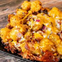 Loaded Tater Tots · Loaded with Jack-Cheddar cheese, bacon, and sautéed onion.