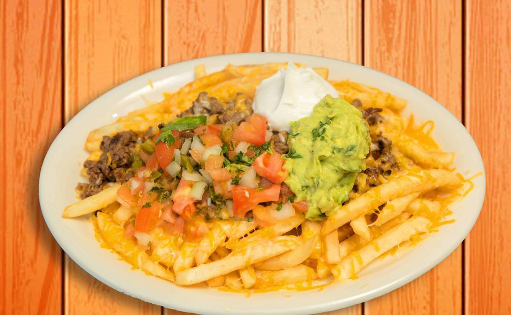 Carne Asada Fries · French fries served with carne asada, melted cheese, pico de gallo, sour cream, fresh guacamole, and diced jalapeños.